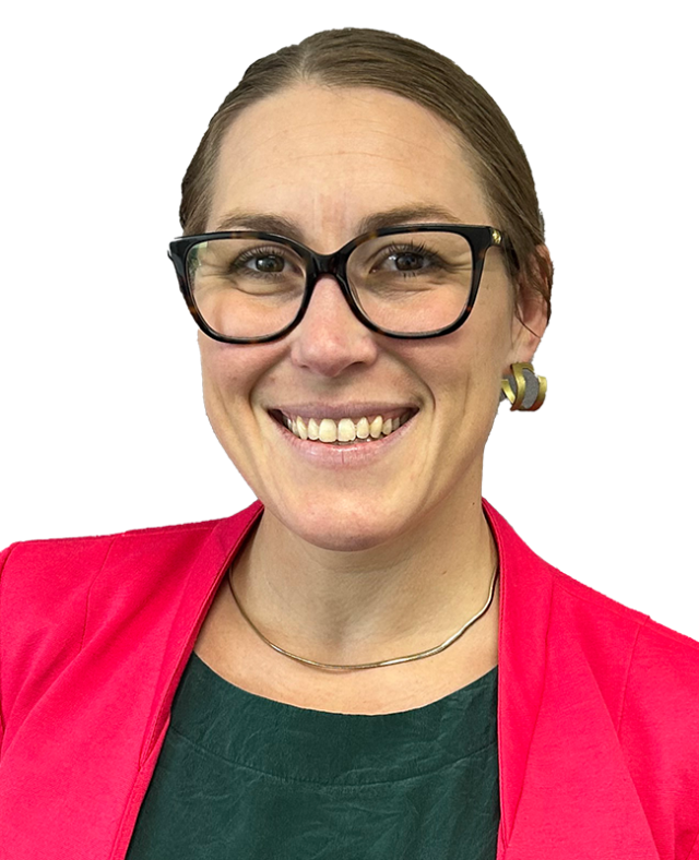 Head‑and‑shoulders studio portrait of a person wearing dark‑framed glasses, a bright blazer, and a dark shirt, photographed against a plain light background.
