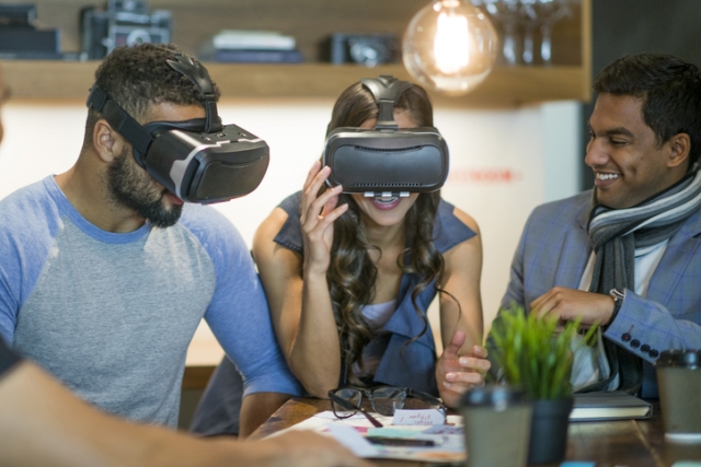 Two people wearing VR headsets