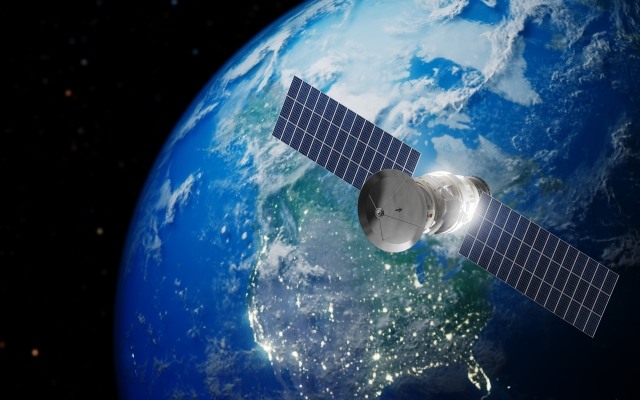 Satellite in space in front of earth