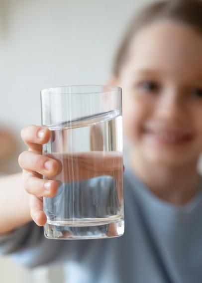 Young boy holding a glass of water