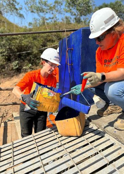 Pouring paint into a bucket at B2P site