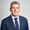 Image of Andy Alder in blue jacket and tie