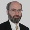 John Siraut in dark jacket and gold tie