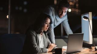 Two people looking at the computer screen