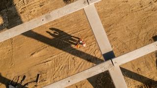 Construction workers under frame structure at site